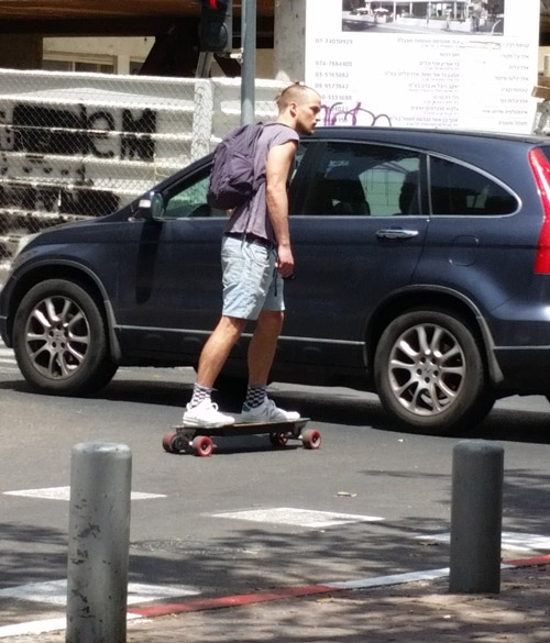 Guy on a home-pimped powered skateboard