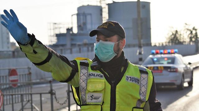 Israeli policeman stopping traffic on Passover eve Israeli policeman stopping traffic on Passover eve